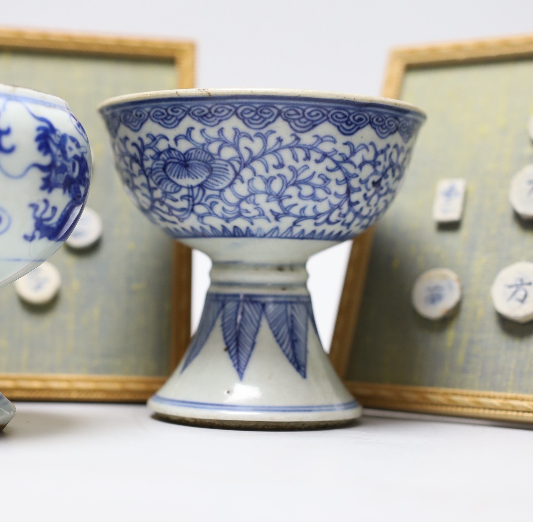 Five 19th century Chinese blue and white stem cups and two framed sets of Thai gaming counters, tallest cup 11cm
